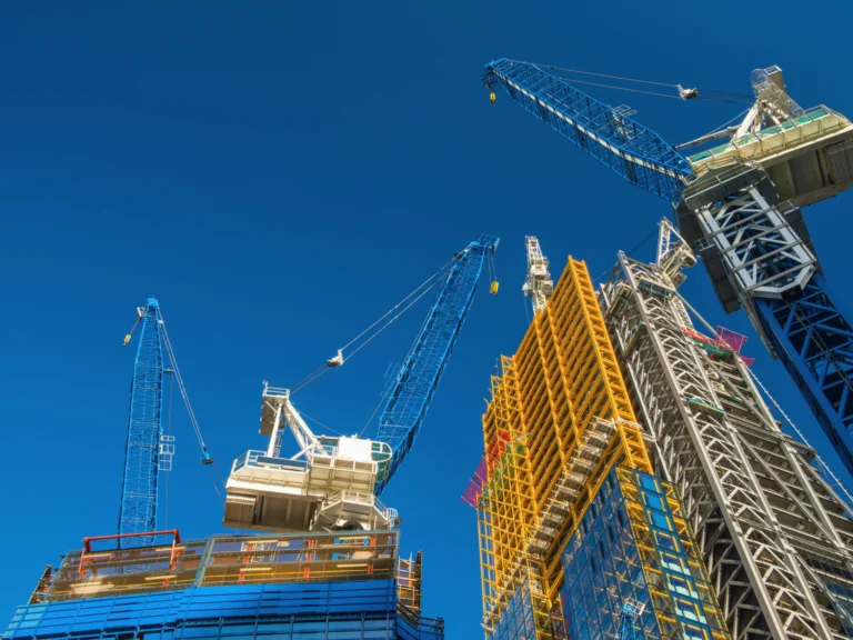 Construction cranes working on a high-rise building development