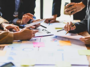 Team reviewing documents and charts during a meeting