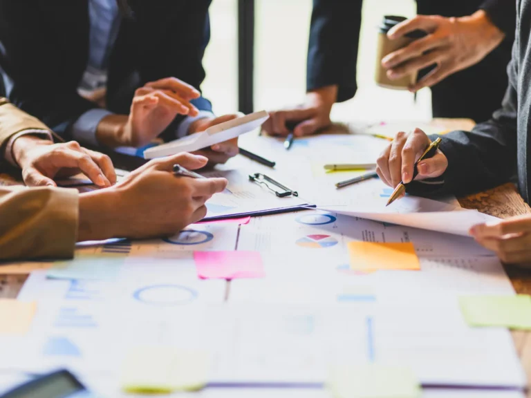 Team reviewing documents and charts during a meeting