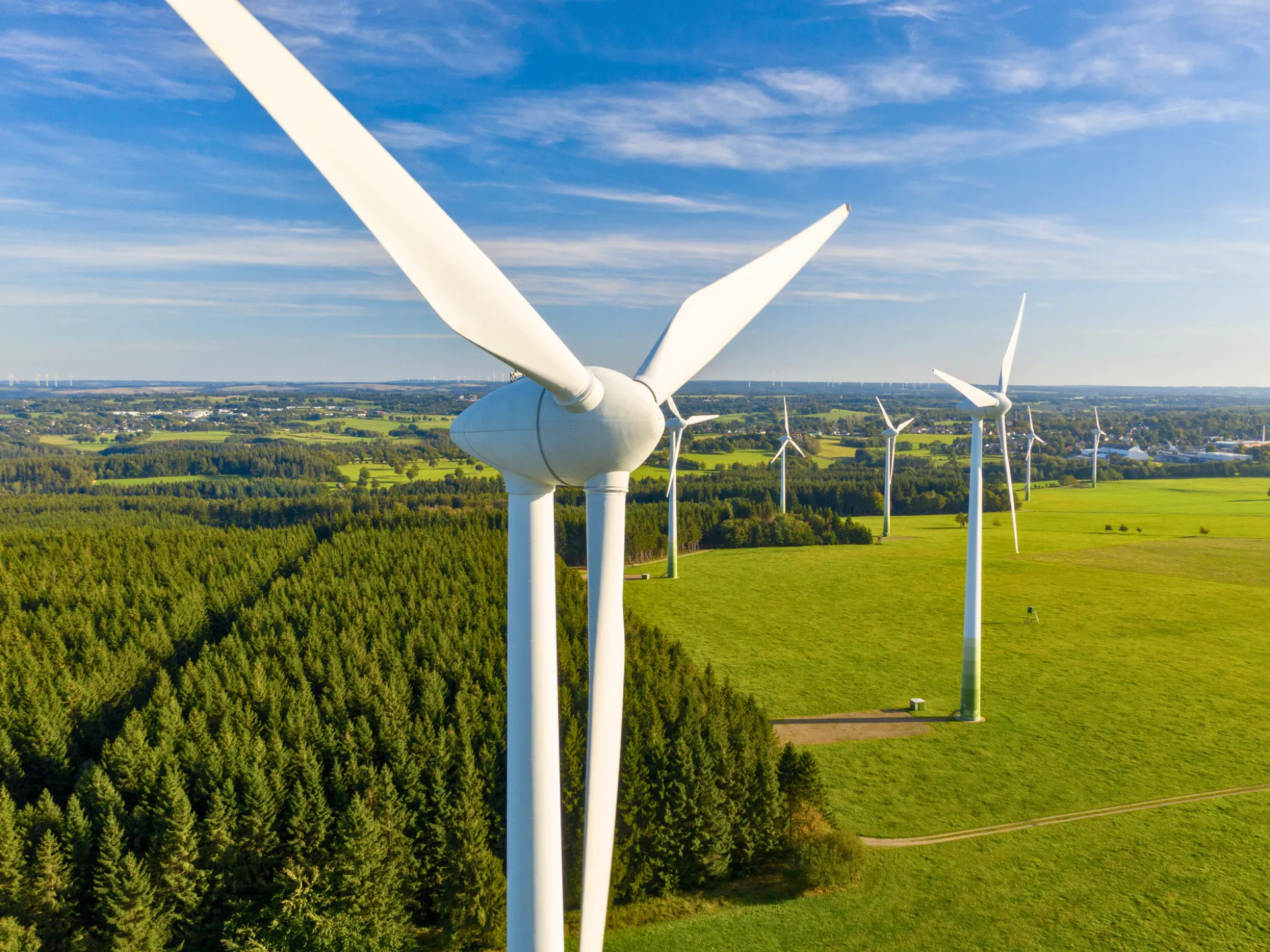 Wind turbines generating renewable energy across a rural landscape